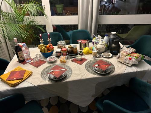 a table with food and bottles of wine on it at A L'OMBRE DE LA TOUR EIFFEL AU BORD DE LA SEINE in Paris