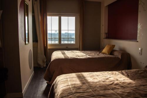 Ένα ή περισσότερα κρεβάτια σε δωμάτιο στο Le Petit Pêcheur