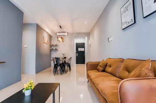 a living room with a couch and a table at The Cove Hillside Residence Ipoh in Ipoh