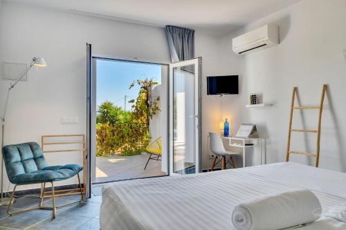 a bedroom with a bed and a view of a patio at Casa la Naranja Boutique B&B in Pedreguer