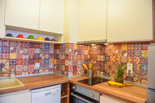 a kitchen with colorful tiles on the wall at Charming sunny apartment+swimming pool in St. St. Constantine and Helena
