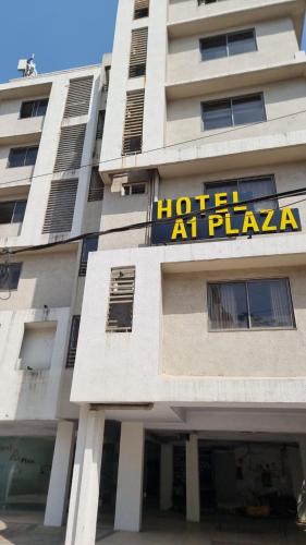 a hotel at plaza with a sign on the side of a building at Hotel A1 Plaza, Ahmedabad in Ahmedabad