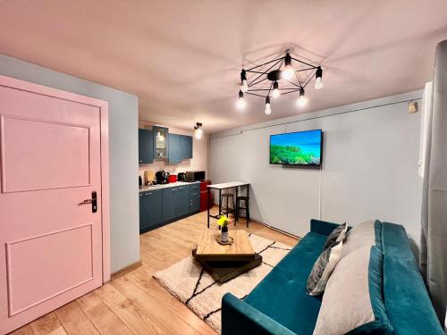 un salon avec un canapé bleu et une table dans l'établissement Old Town City Center Apartments, à Braşov