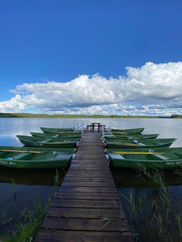 a group of boats tied to a dock on a lake at Jaundzirnieki in Valdemārpils