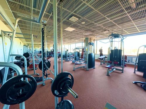 a gym with lots of equipment in a building at Tamme staadioni hostel in Tartu