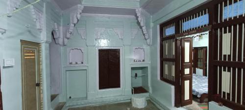 a room with white walls and a window and a door at Feel Aesthetic Kashi Home Stay in Varanasi