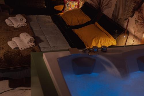 a living room with a bed and a tv at Ortigia Sitari suites in Siracusa