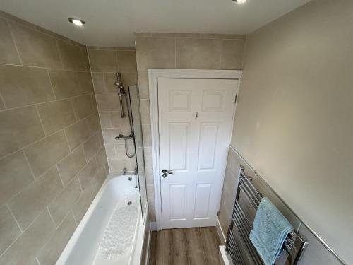 a bathroom with a shower and a bath tub at 2-Bed Apartment in Coleshill in Birmingham