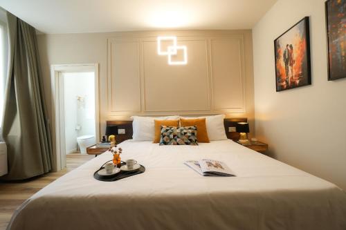 a bedroom with a large bed with a book on it at Mazzini's Rooms in Modena