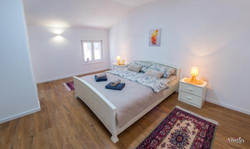 a bedroom with a bed with two pillows on it at Apartment Novax - Free Parking in Mostar