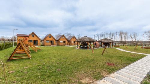 a playground in a park with a group of houses at Nowodworska, Sun & Snow in Stegna