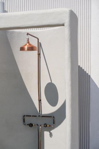 a lamp in the corner of a room next to a wall at Euforia Retreat and Spa in Eforie Nord