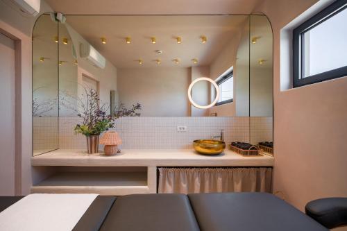 a bathroom with a counter with a mirror at Euforia Retreat and Spa in Eforie Nord