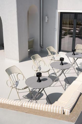 a group of tables and chairs on a patio at Euforia Retreat and Spa in Eforie Nord
