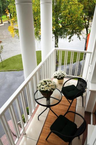 a balcony with two chairs and a table on a porch at Villa Solankowa in Inowrocław