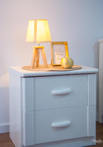 a table with a lamp and a picture on it at Apartment Novax - Free Parking in Mostar