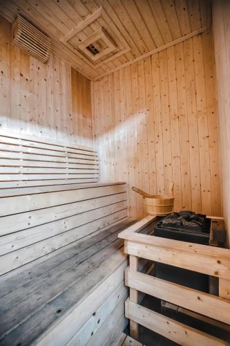 an empty wooden sauna with a stove in it at The Cove Hillside Residence Ipoh in Ipoh