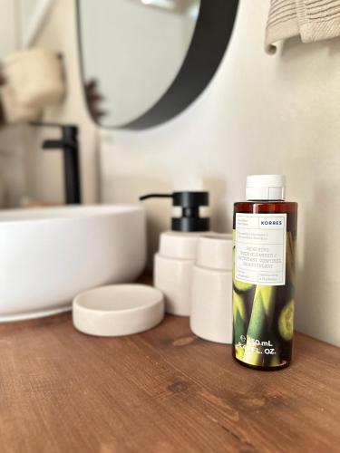 a bottle of soap sitting on a counter in a bathroom at Anerada Cottages in Apsiou