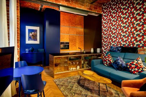 a living room with a blue couch and a table at RentPlanet - Nowa Papiernia in Wrocław