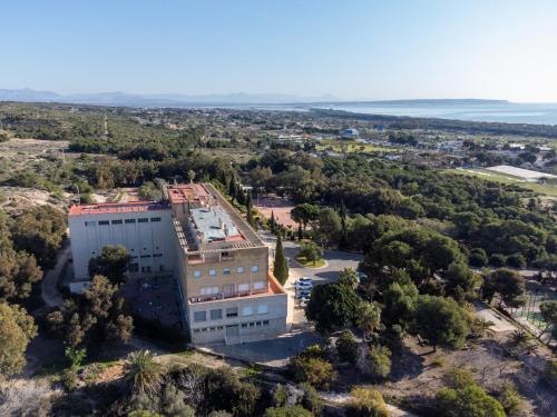 an aerial view of a building on a hill at Costablanca Explore Hostel Sports & Events in La Marina