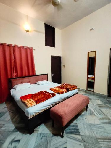 a bedroom with a bed and a red curtain at Shantiniketan 4BHK Comfortable Family Stay in Ayodhya in Ayodhya