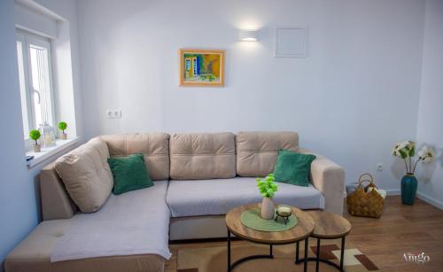 a living room with a couch and a table at Apartment Novax - Free Parking in Mostar