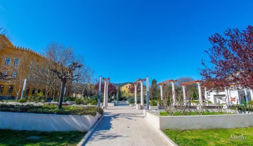 a walkway in front of a building with flags at Apartment Novax - Free Parking in Mostar