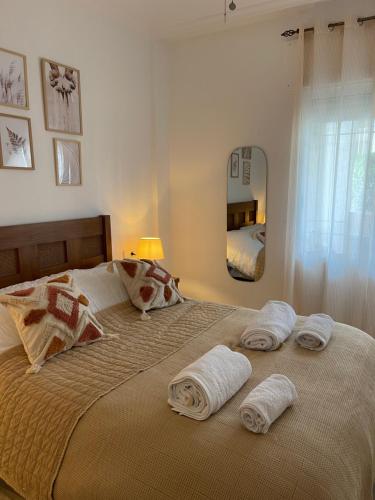 a bedroom with a large bed with towels on it at Holiday Home Amari - Residencia Albatros in Los Alcázares