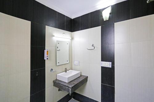 a bathroom with a sink and a mirror at Comfort stay Noida sector 19 in Noida