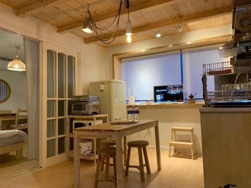 a kitchen with a table and chairs and a refrigerator at liilliil Residence Seoul in Seoul
