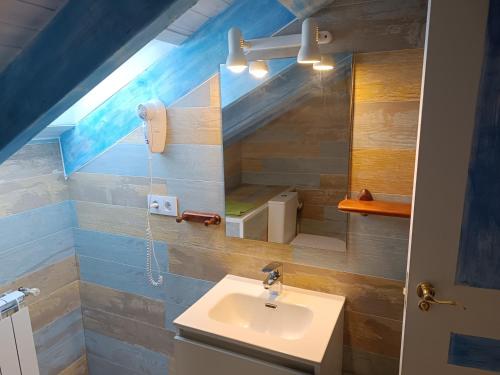 a bathroom with a sink and a mirror at PENSION ALFOZ de RONDIELLA in Piñeres