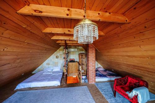 ガールドニにあるKisházのベッドとシャンデリアが備わる屋根裏部屋です。