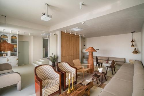 a living room with a couch and chairs at Euforia Retreat and Spa in Eforie Nord