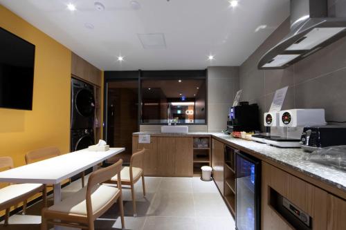 a kitchen with a table and chairs in a room at Incheon Browndot Hotel Nonhyeon Soraepogu in Incheon