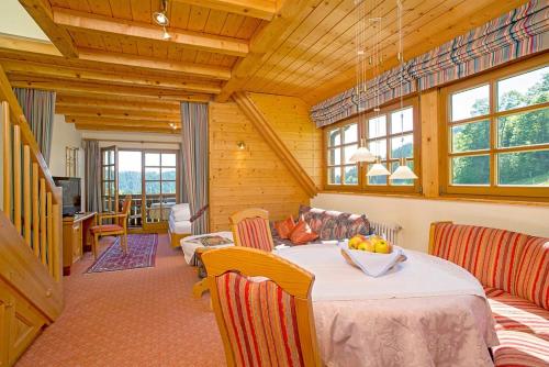 a dining room with a table with a bowl of fruit on it at Ferienhaus Esche in Hinterzarten