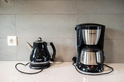 a blender sitting on a counter next to a tea kettle at Beachfront Artemida Retreat - Peony Seabreeze Gem in Artemida