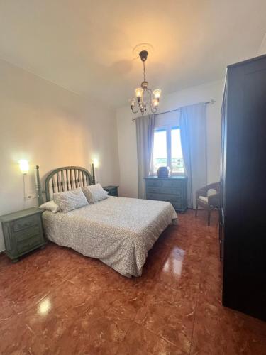 a bedroom with a bed and a chandelier at Aceró Home in Los Llanos de Aridane