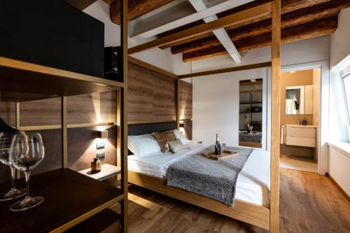 a bedroom with a loft bed with a bedside table at Pepenero Camera con Vista in Pavia dʼUdine