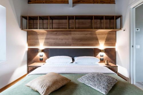 a bedroom with a large bed with two pillows at Pepenero Camera con Vista in Pavia dʼUdine