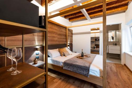 a bedroom with a large bed and wooden walls at Pepenero Camera con Vista in Pavia dʼUdine