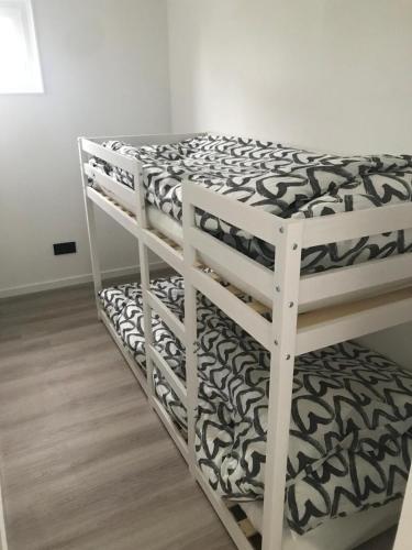 a couple of bunk beds in a room at Uniek overnachten in een Tiny House op de Appelhof in Wommels