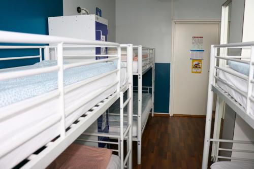 a room with several bunk beds in a hospital at CheapSleep Hostel Helsinki in Helsinki