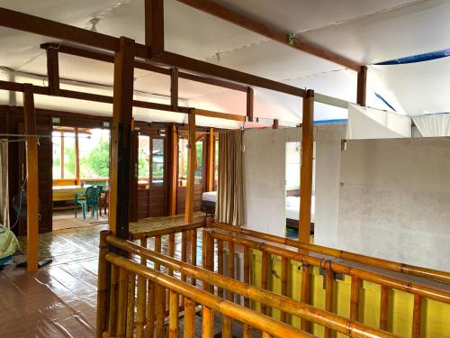a house being remodeled with a wooden railing at NASRUL HOUSE HOMESTAY FOR BACKPACKERS in Maros
