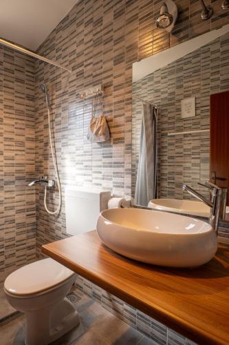 a bathroom with a sink and a toilet and a tub at Barba Damir in Pag