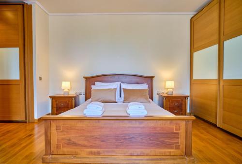 a bedroom with a wooden bed with two night stands at Utopia Beach Villa in Litherés