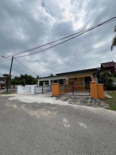 a house with a fence on the side of the road at Kicauan RoomStay #2 Kuala Berang-Free WiFi & Netflix for 2 Pax in Kuala Berang