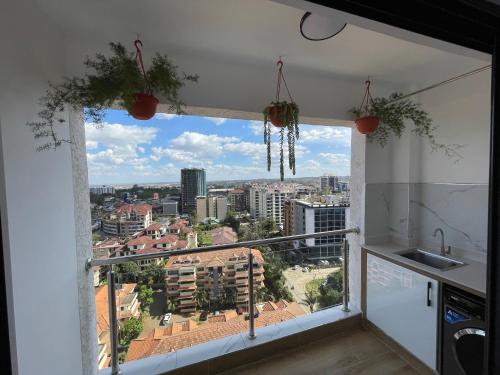 a kitchen window with a view of a city at Smarthome Serviced Apartment in Nairobi