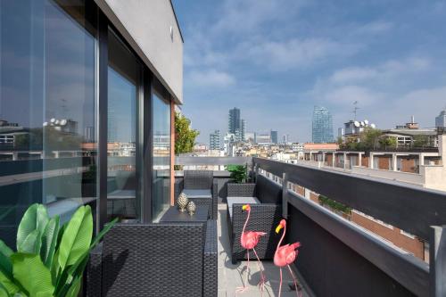 a balcony with chairs and tables on a building at Milan Royal Suites - Centro in Milan