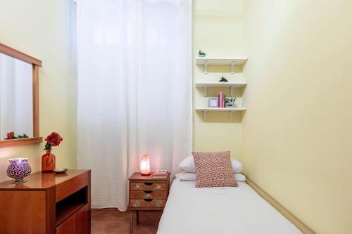 a bedroom with a bed and a desk with a candle at Casa Rio in Rome