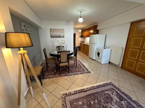 a kitchen and dining room with a table and refrigerator at Bratis House 3 in Vartholomio